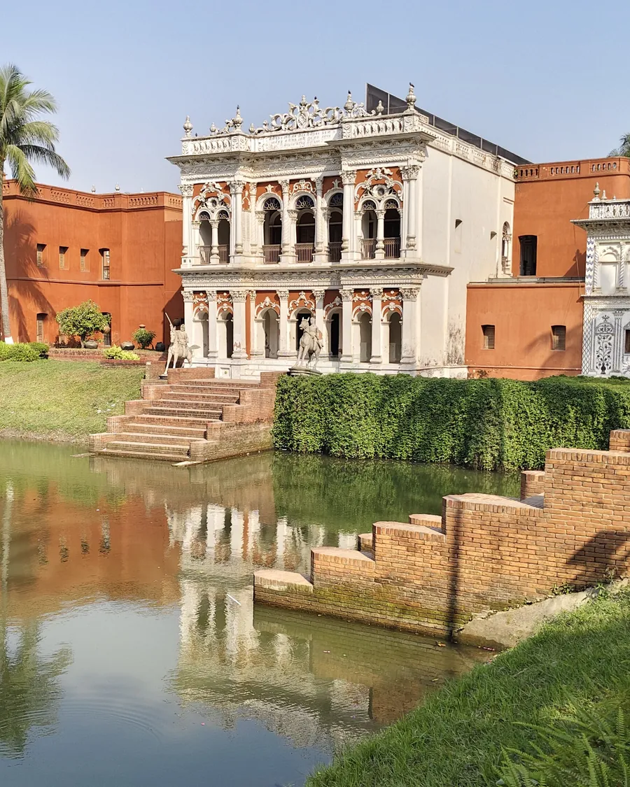 The folk art museum building reflected in a pond at Sonargaon